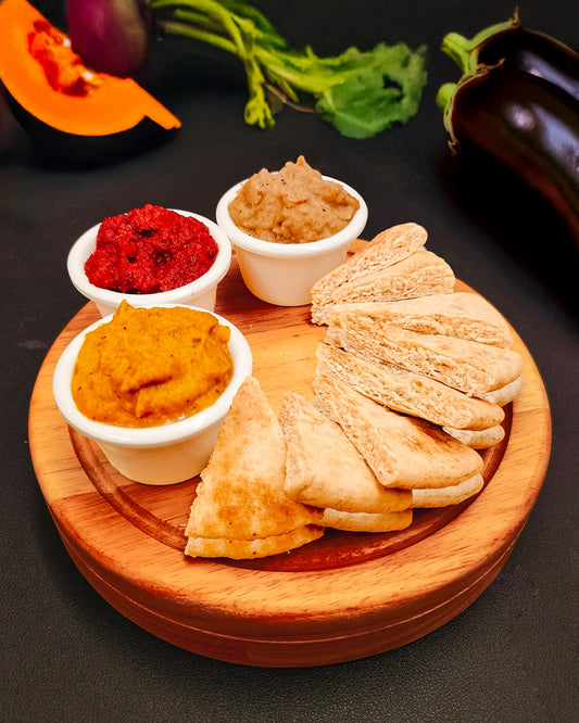 Pita bread with different vegetable hummus, including pumpkin, beetroot and aubergine