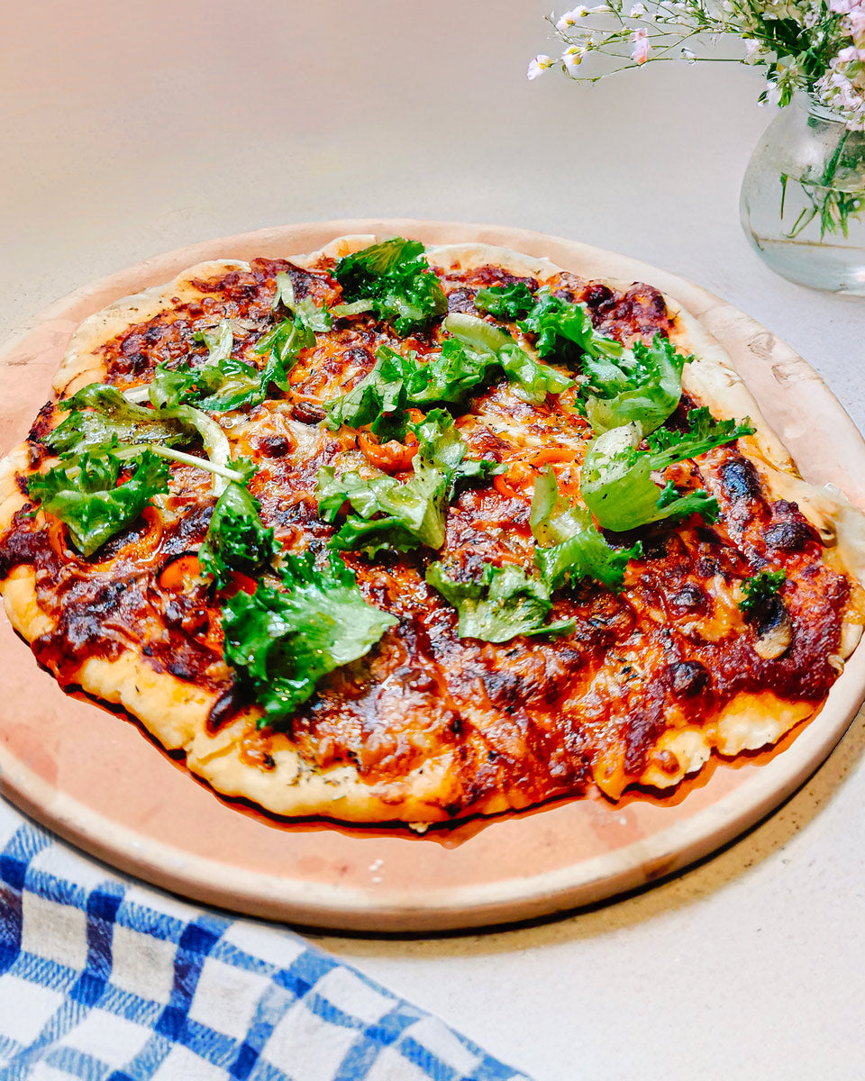 Homemade pizza with spicy salami on a hot pepper base