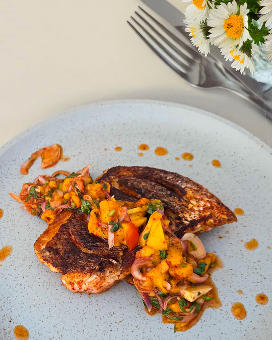 Pan-seared red snapper/salmon with crispy skin and generous spread of mango salsa